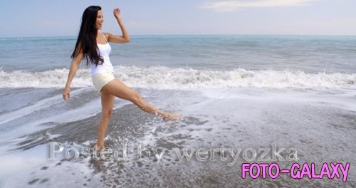 Videohive - Carefree Woman Kicking Up Water On Tropical Beach - 
11694195